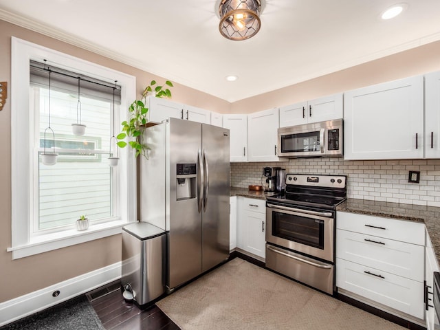 624 Oakwood Ave, Columbus, OH 43205 - kitchen featuring stainless steel appliances, tasteful backsplash, crown molding, dark stone counters, and white cabinetry