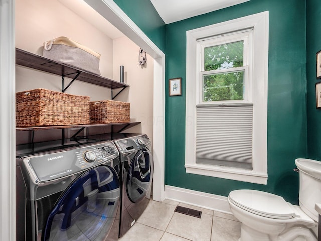 624 Oakwood Ave, Columbus, OH 43205 - washroom featuring washing machine and clothes dryer and light tile patterned floors