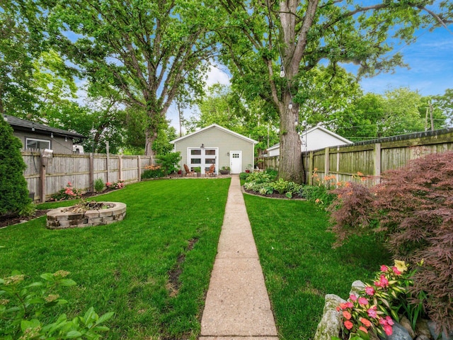 624 Oakwood Ave, Columbus, OH 43205 - fenced backyard with a fire pit and an outbuilding