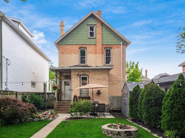 624 Oakwood Ave, Columbus, OH 43205 - rear view of house featuring an outdoor fire pit, brick siding, a patio, and a chimney