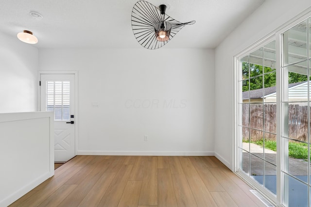 3048 Wallingford Ave, Columbus, OH 43231 - spare room featuring light wood-type flooring, plenty of natural light, and a smoke detector