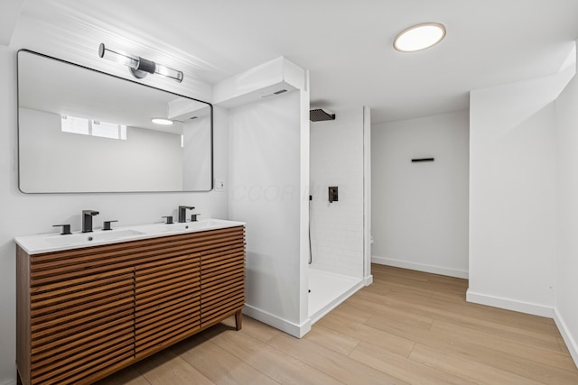 3048 Wallingford Ave, Columbus, OH 43231 - bathroom with a tile shower, double vanity, and wood finished floors