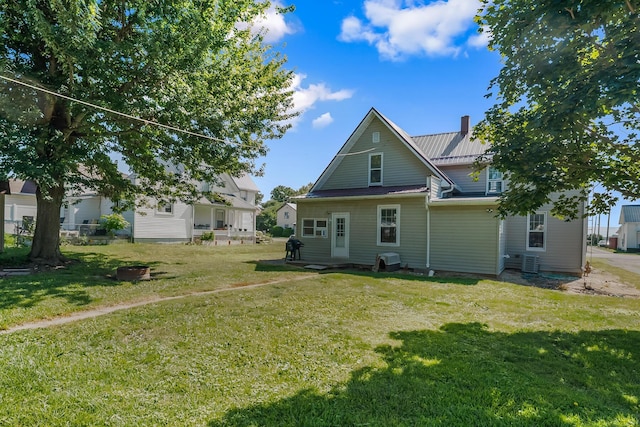 405 N Main St, Nevada, OH 44849 - rear view of house featuring a yard, a metal roof, and a chimney
