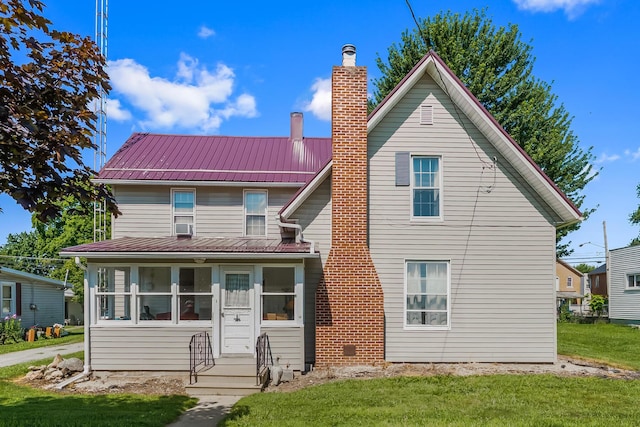 405 N Main St, Nevada, OH 44849 - view of front facade featuring a chimney, a front yard, and a metal roof