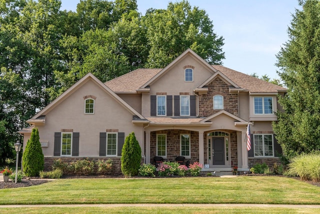 6820 Mahogany Dr, Galena, OH 43021 - view of front of home with stone siding, stucco siding, and a front yard