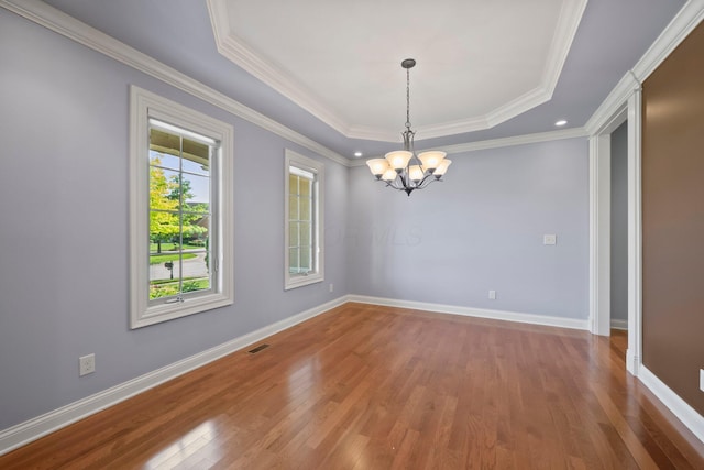 6820 Mahogany Dr, Galena, OH 43021 - spare room with wood finished floors, a chandelier, a raised ceiling, and ornamental molding