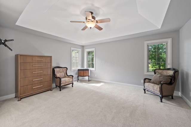 6820 Mahogany Dr, Galena, OH 43021 - living area featuring a raised ceiling, ceiling fan, healthy amount of natural light, and light colored carpet