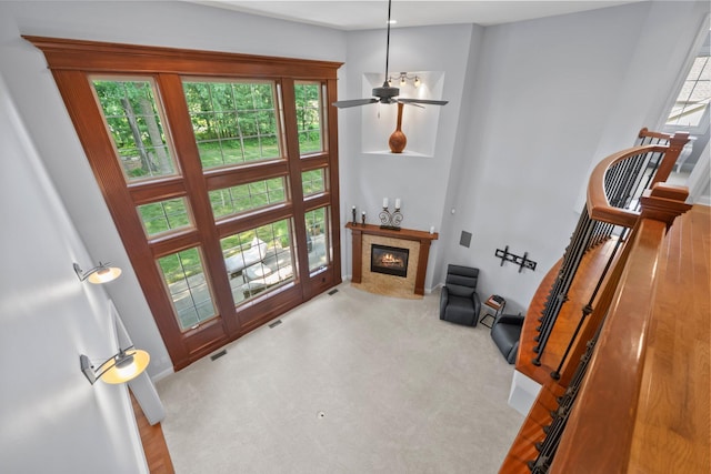 6820 Mahogany Dr, Galena, OH 43021 - carpeted living room with a fireplace, a towering ceiling, and ceiling fan