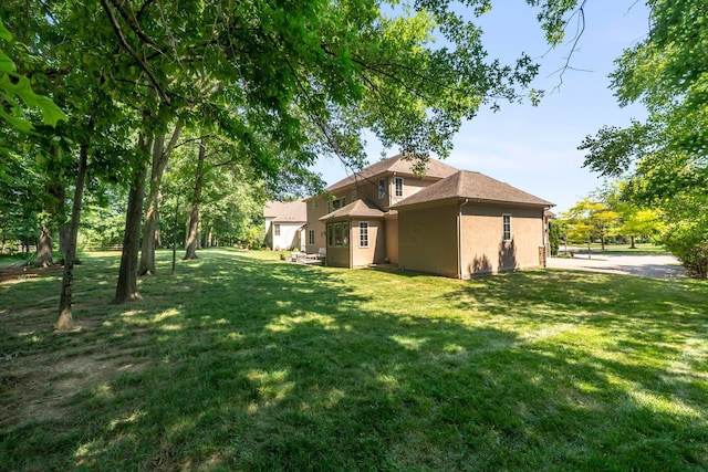 6820 Mahogany Dr, Galena, OH 43021 - back of property with stucco siding, a lawn, and a shingled roof