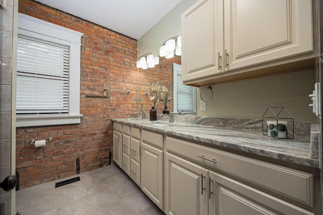 199 E Gates St, Columbus, OH 43206 - bathroom with brick wall and double vanity