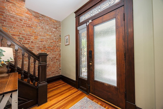 199 E Gates St, Columbus, OH 43206 - foyer featuring wood finished floors, stairs, and brick wall