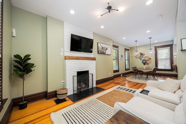 199 E Gates St, Columbus, OH 43206 - living area featuring wood finished floors, a brick fireplace, and recessed lighting