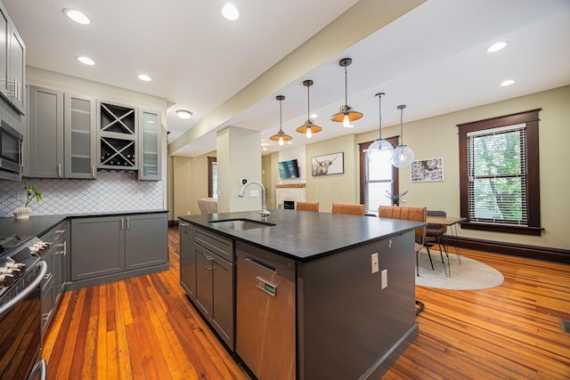 199 E Gates St, Columbus, OH 43206 - kitchen featuring stainless steel appliances, dark countertops, wood-type flooring, and recessed lighting
