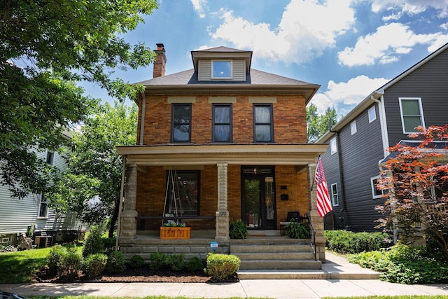 199 E Gates St, Columbus, OH 43206 - traditional style home with brick siding, a porch, and a chimney