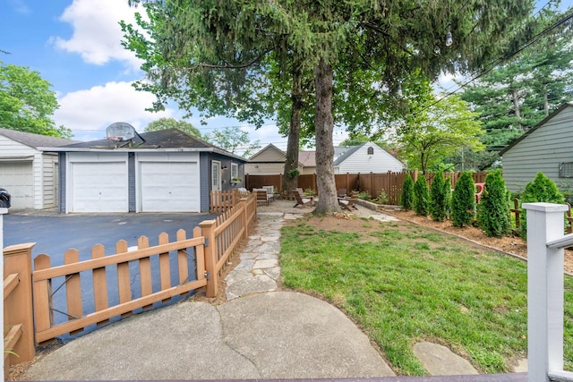 70 N Cassingham Rd, Columbus, OH 43209 - fenced yard featuring an outdoor structure and a detached garage