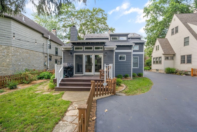 70 N Cassingham Rd, Columbus, OH 43209 - back of house with a wooden deck, a chimney, a shingled roof, and french doors