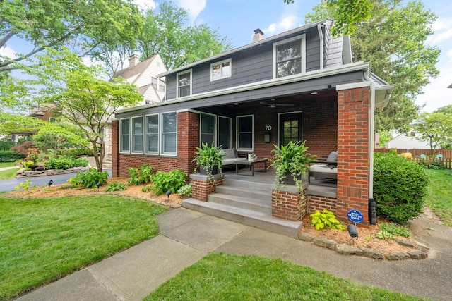 70 N Cassingham Rd, Columbus, OH 43209 - view of front of home with brick siding, covered porch, and a front yard