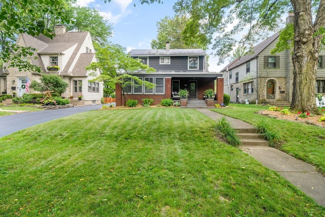 70 N Cassingham Rd, Columbus, OH 43209 - view of front of home with a front lawn, brick siding, and covered porch