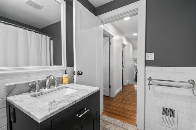 70 N Cassingham Rd, Columbus, OH 43209 - bathroom with tile walls, vanity, and recessed lighting