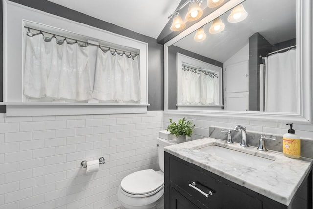 70 N Cassingham Rd, Columbus, OH 43209 - full bathroom with vanity, tile walls, and lofted ceiling