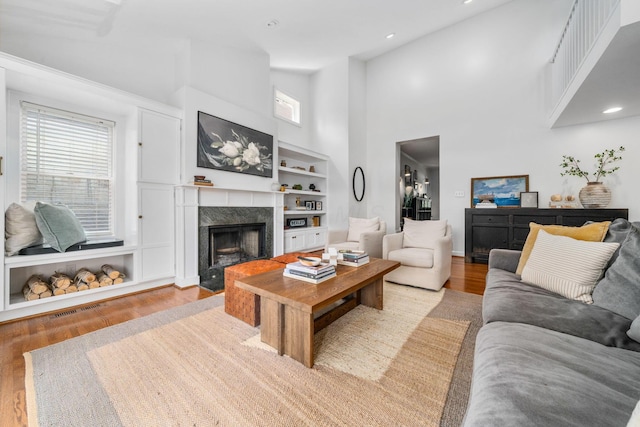 70 N Cassingham Rd, Columbus, OH 43209 - living area with wood finished floors, a high ceiling, a premium fireplace, recessed lighting, and built in features