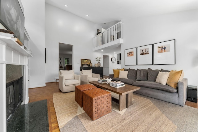 70 N Cassingham Rd, Columbus, OH 43209 - living room featuring a fireplace, wood finished floors, a high ceiling, and recessed lighting