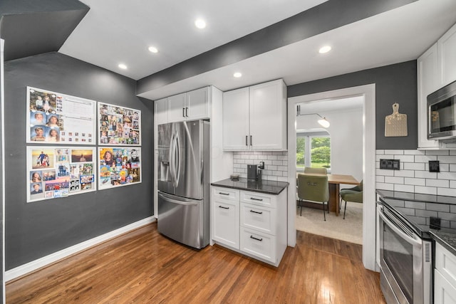 70 N Cassingham Rd, Columbus, OH 43209 - kitchen featuring stainless steel appliances, dark wood-style flooring, white cabinets, decorative backsplash, and recessed lighting