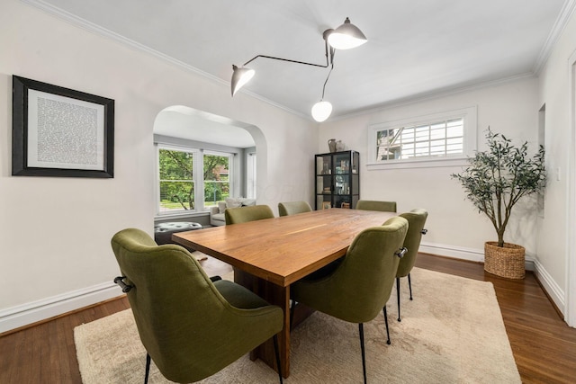 70 N Cassingham Rd, Columbus, OH 43209 - dining room featuring arched walkways, crown molding, healthy amount of natural light, and dark wood-type flooring