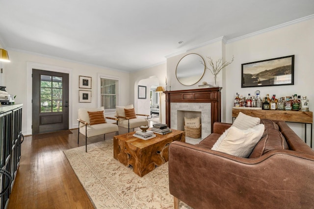 70 N Cassingham Rd, Columbus, OH 43209 - living area with wood finished floors, ornamental molding, arched walkways, and a fireplace