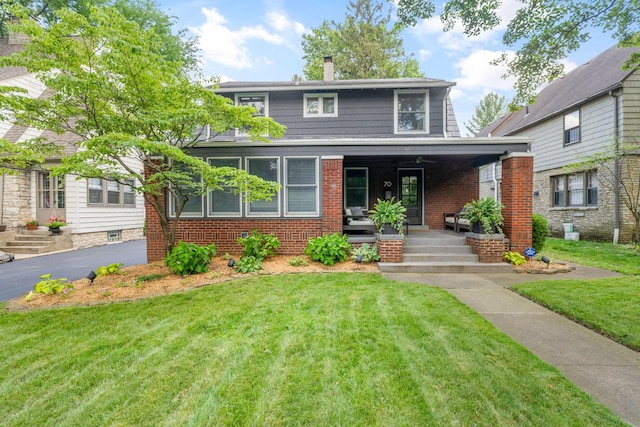 70 N Cassingham Rd, Columbus, OH 43209 - view of front facade with a porch, a front yard, brick siding, and a chimney