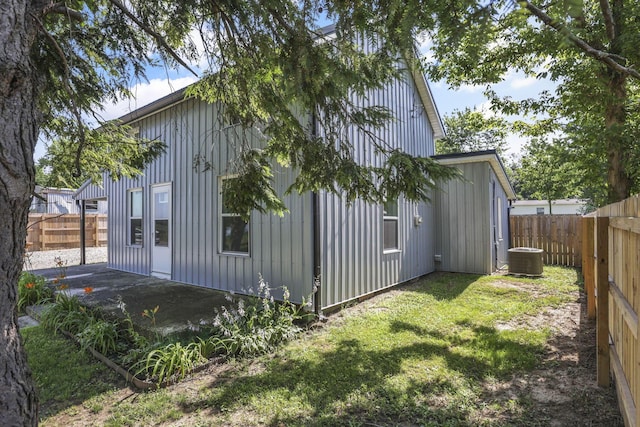 8898 Baker Rd, Stoutsville, OH 43154 - view of home's exterior featuring board and batten siding, a fenced backyard, and a patio