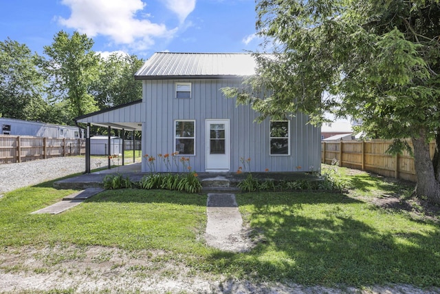 8898 Baker Rd, Stoutsville, OH 43154 - view of front facade with a fenced backyard, a metal roof, and board and batten siding