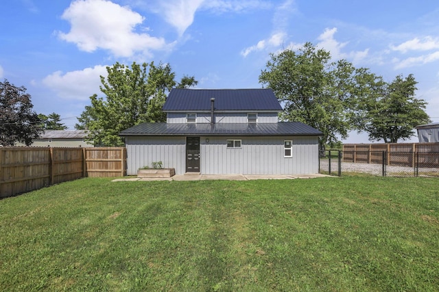 8898 Baker Rd, Stoutsville, OH 43154 - back of house featuring a fenced backyard, board and batten siding, and a metal roof