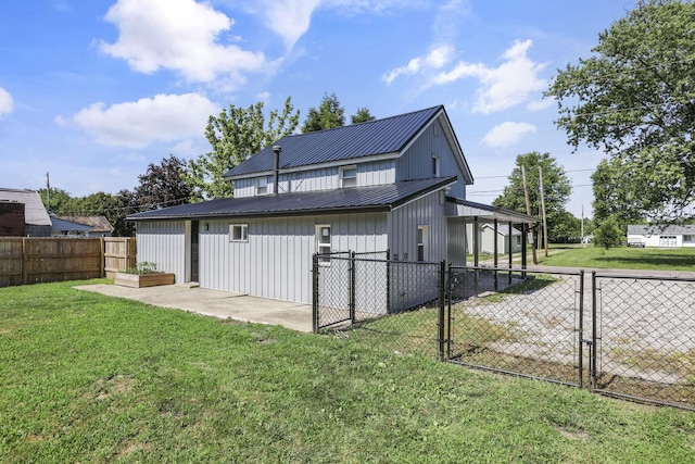 8898 Baker Rd, Stoutsville, OH 43154 - back of property featuring a gate, a fenced backyard, a metal roof, and board and batten siding