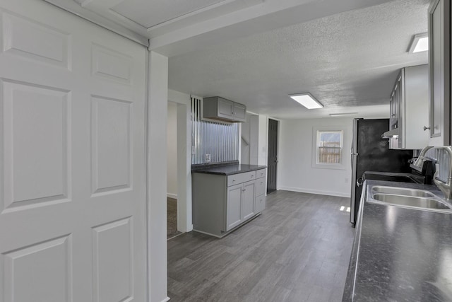 8898 Baker Rd, Stoutsville, OH 43154 - kitchen featuring dark countertops, dark wood finished floors, a textured ceiling, exhaust hood, and stove