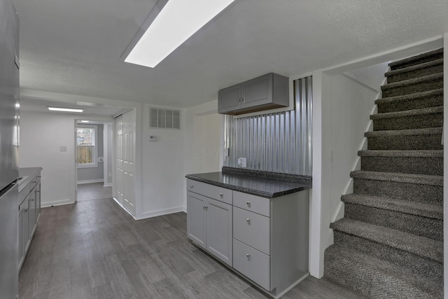 8898 Baker Rd, Stoutsville, OH 43154 - kitchen with dark wood-style flooring, gray cabinets, and dark countertops