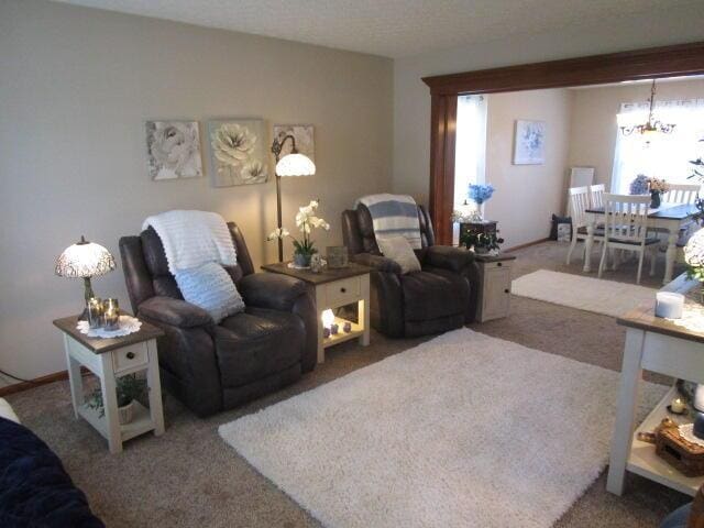 5669 Maplewood Ct, Lewis Center, OH 43035 - carpeted living room with a chandelier
