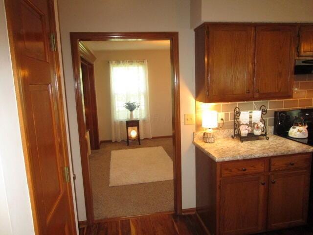 5669 Maplewood Ct, Lewis Center, OH 43035 - kitchen with extractor fan, brown cabinetry, backsplash, and range