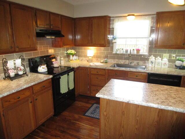 5669 Maplewood Ct, Lewis Center, OH 43035 - kitchen featuring black appliances, under cabinet range hood, dark wood finished floors, and backsplash