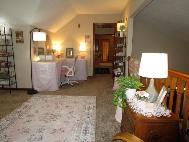 5669 Maplewood Ct, Lewis Center, OH 43035 - carpeted living area featuring lofted ceiling and stairway