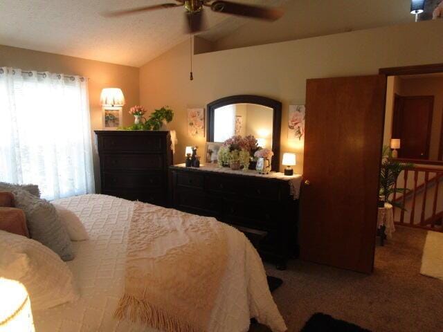5669 Maplewood Ct, Lewis Center, OH 43035 - bedroom with vaulted ceiling, carpet flooring, and a ceiling fan