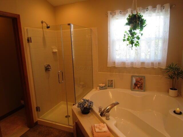 5669 Maplewood Ct, Lewis Center, OH 43035 - bathroom featuring a stall shower and a garden tub