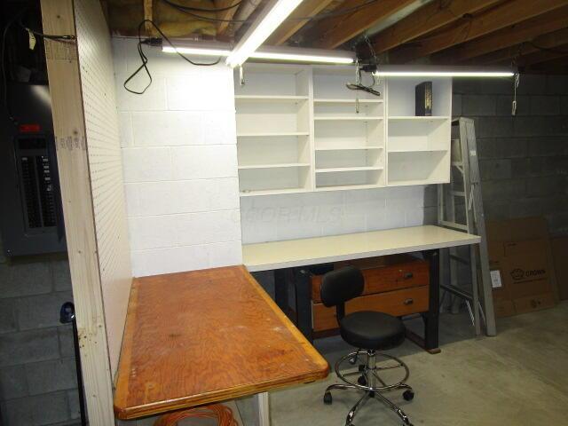 5669 Maplewood Ct, Lewis Center, OH 43035 - unfurnished office featuring concrete block wall, concrete flooring, and electric panel