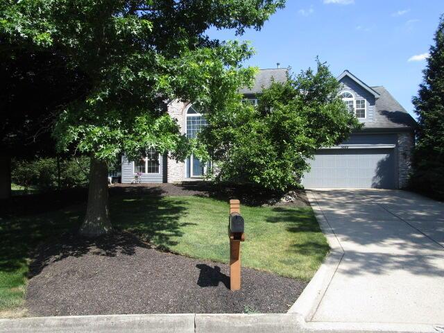 5669 Maplewood Ct, Lewis Center, OH 43035 - view of property hidden behind natural elements with concrete driveway and a front lawn