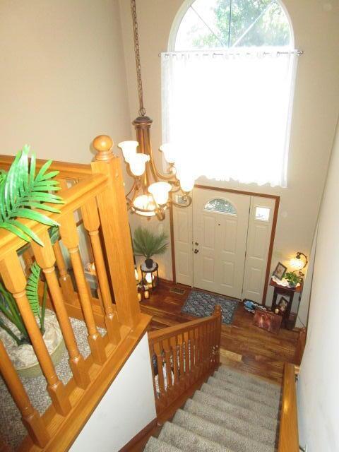 5669 Maplewood Ct, Lewis Center, OH 43035 - foyer with a chandelier, stairs, and a high ceiling
