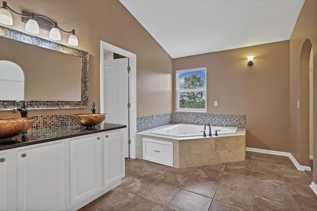 3902 Rivers Run Dr, Lewis Center, OH 43035 - bathroom featuring double vanity, lofted ceiling, a bath, and decorative backsplash