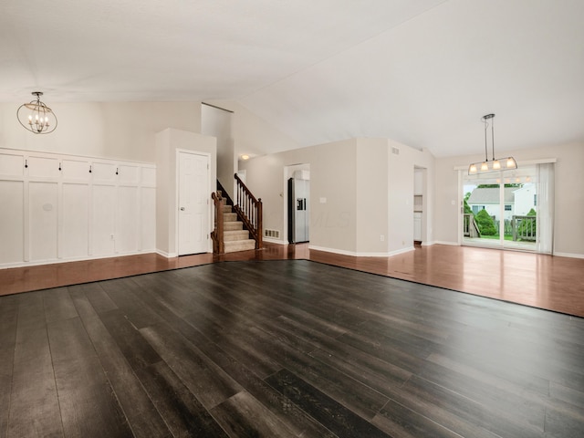 419 Sycamore Creek St, Pickerington, OH 43147 - unfurnished living room with dark wood-style floors, a chandelier, lofted ceiling, and stairway