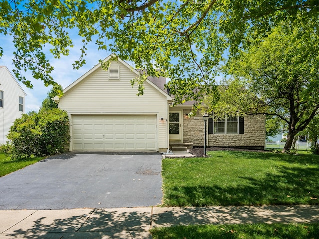 419 Sycamore Creek St, Pickerington, OH 43147 - view of front of house featuring driveway, an attached garage, a front lawn, and stone siding