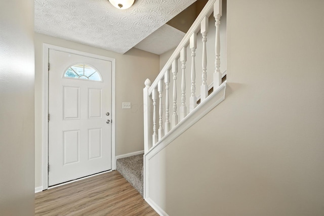 1771 Fern Trail Dr, Lancaster, OH 43130 - entryway with stairway, wood finished floors, and a textured ceiling