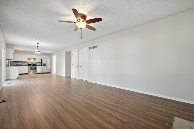 1771 Fern Trail Dr, Lancaster, OH 43130 - unfurnished living room featuring ceiling fan, wood finished floors, and a textured ceiling